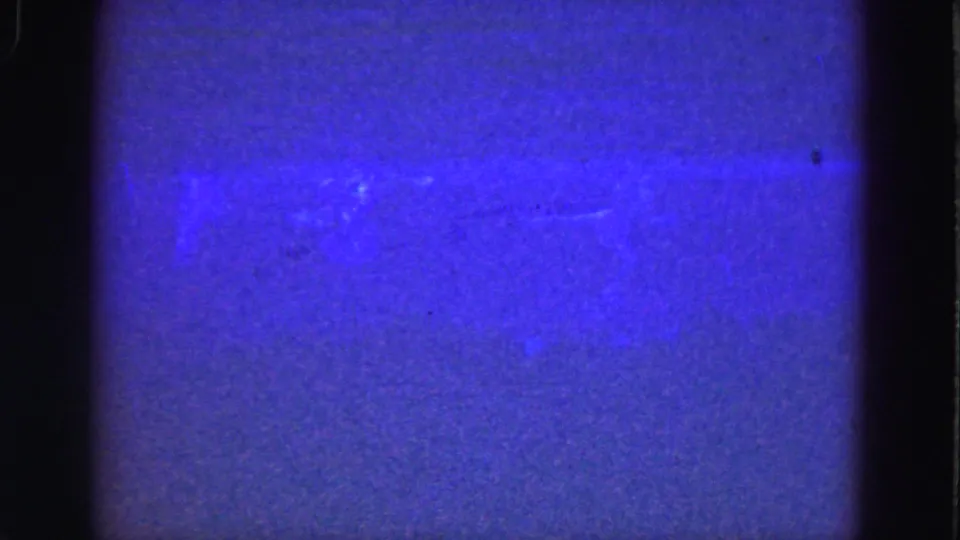 Florida Everglades 1975 8mm underwater frame with blue haze, film grain, and a faint light streak through the water.