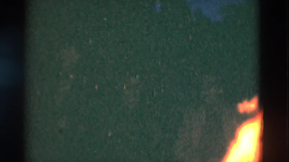 1975 8mm frame with a cropped campfire glow at night, recorded in Somerset, Kentucky according to metadata.