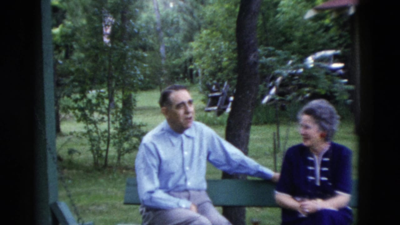 The man rests an arm along the bench as the woman smiles in a leafy Somerset, Kentucky yard, based on the supplied 1975 metadata.