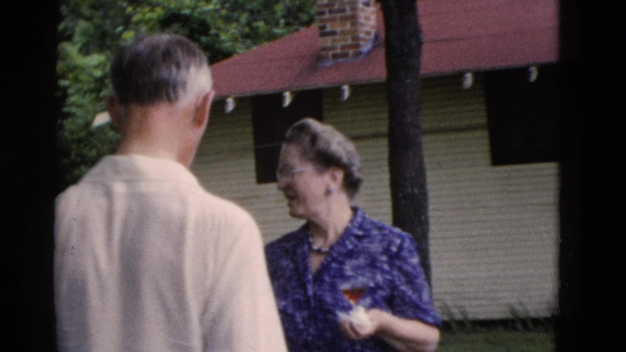 An older man in a light shirt talks with a smiling woman in a blue patterned blouse holding a cocktail glass in Somerset, Kentucky.