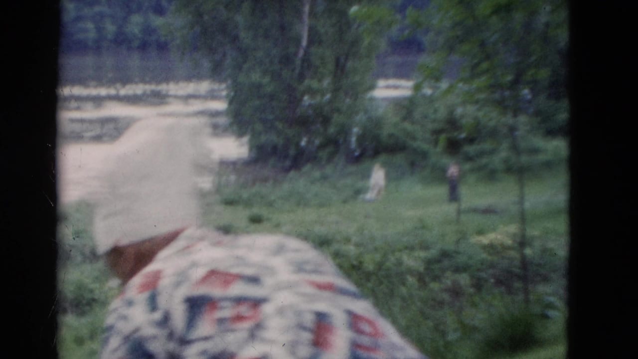 1975 Somerset, Kentucky frame with a man in a white cap and patterned shirt facing a lawn and trees at the retreat site.