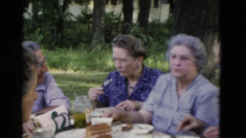 1975 Somerset, Kentucky frame with older women seated at a shaded picnic table while others remain partly visible nearby.