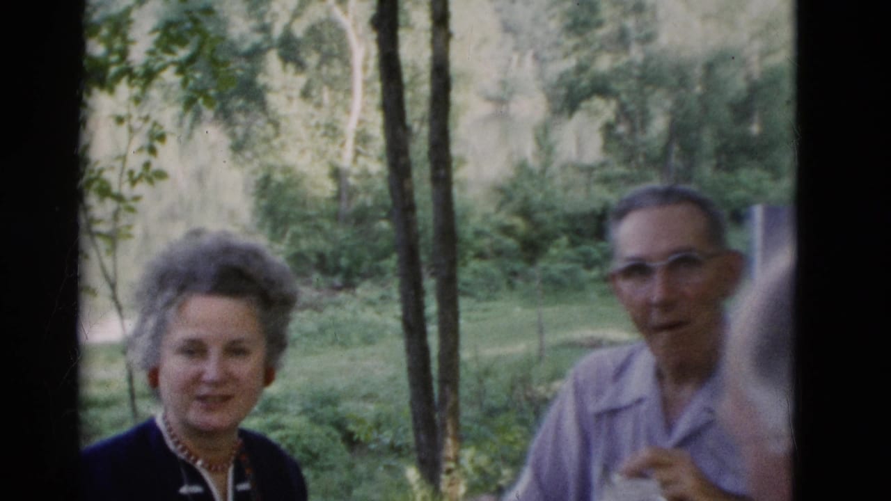 An older woman smiles near an older man in glasses during a 1975 outdoor gathering in Somerset, Kentucky.