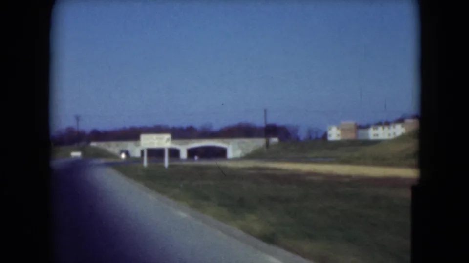 1975 Middletown, Pennsylvania frame showing a road approaching a stone bridge area with a roadside sign and low buildings.