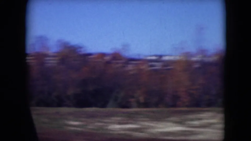 Rural Middletown, Pennsylvania view with an open foreground, distant autumn tree line, and blue sky in soft 8mm motion blur.