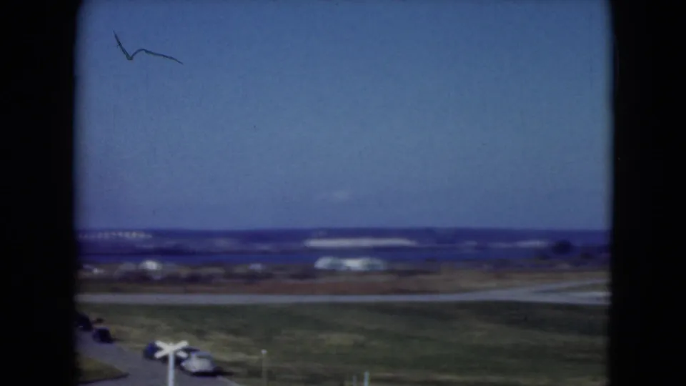 1975 Middletown, Pennsylvania frame with open fields, intersecting roads, distant low buildings, and visible 8mm frame edges.