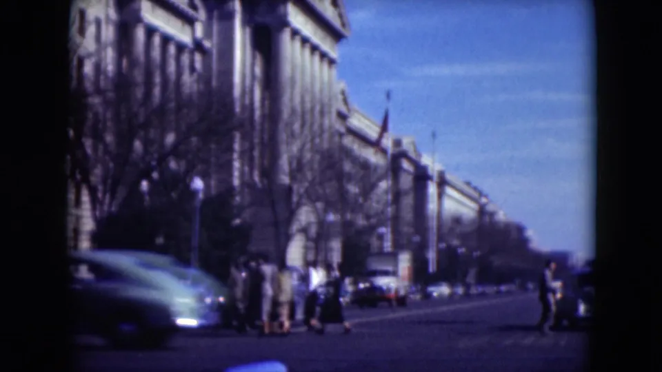 Middletown, Pennsylvania street scene from 1975 showing pedestrians near cars and a large columned building, with 8mm motion blur.