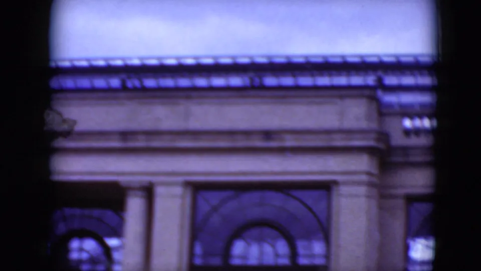 1975 Middletown, Pennsylvania view of an older-looking facade with paired columns, arched windows and cool film color.