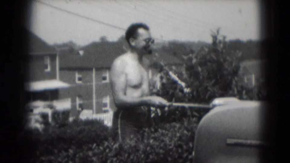 The final frame keeps the man and grill in view, with a residential neighborhood visible behind the backyard scene.