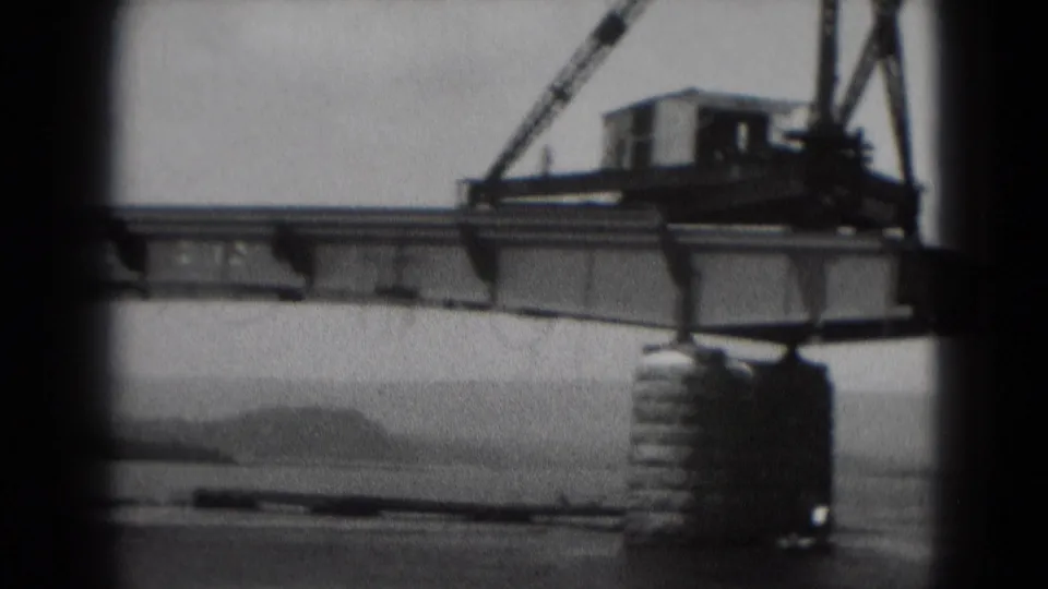 Middletown, Pennsylvania bridge view with a crane or maintenance rig on the deck area above a large pier and river.
