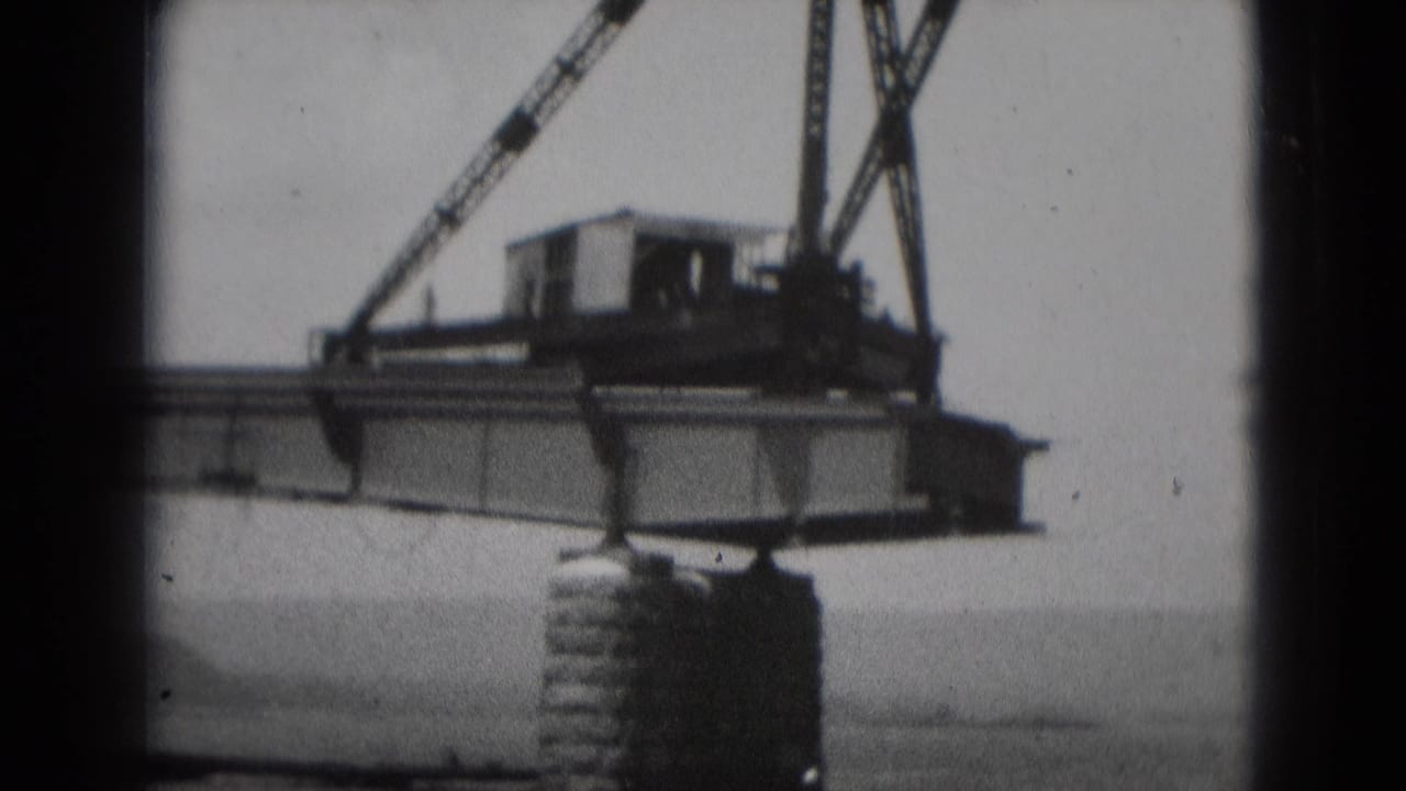 Crane boom and beam remain suspended above the waterline.
