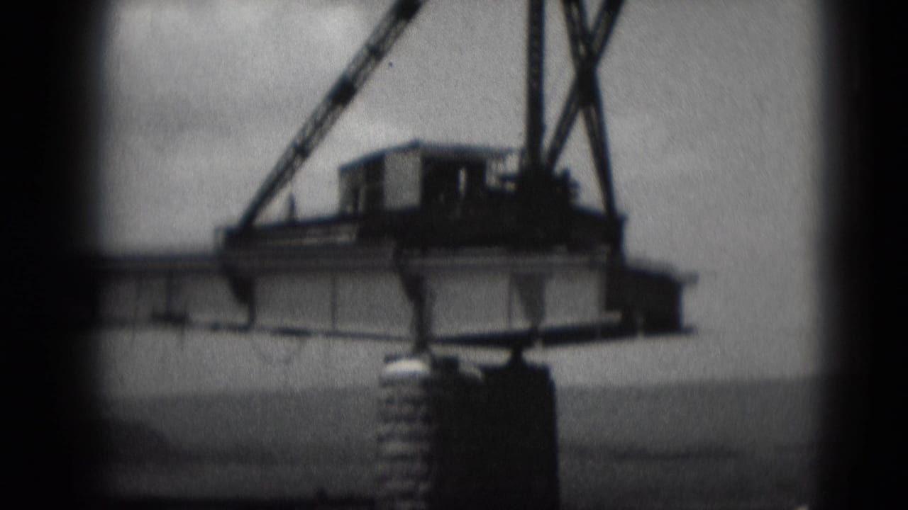 1975 Middletown, Pennsylvania 8mm view of a bridge over water, with heavy equipment on the span and a concrete support pier below.
