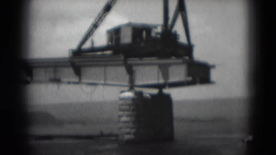 Bridge structure in Middletown, Pennsylvania, with a crane-like machine on the deck and a concrete pier rising from the water area.