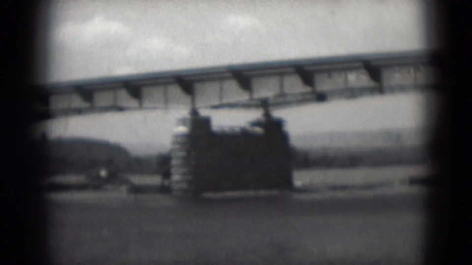 1975 home-movie view of a bridge over water, showing a concrete pier, underside details, and distant shoreline in Middletown, Pennsylvania.