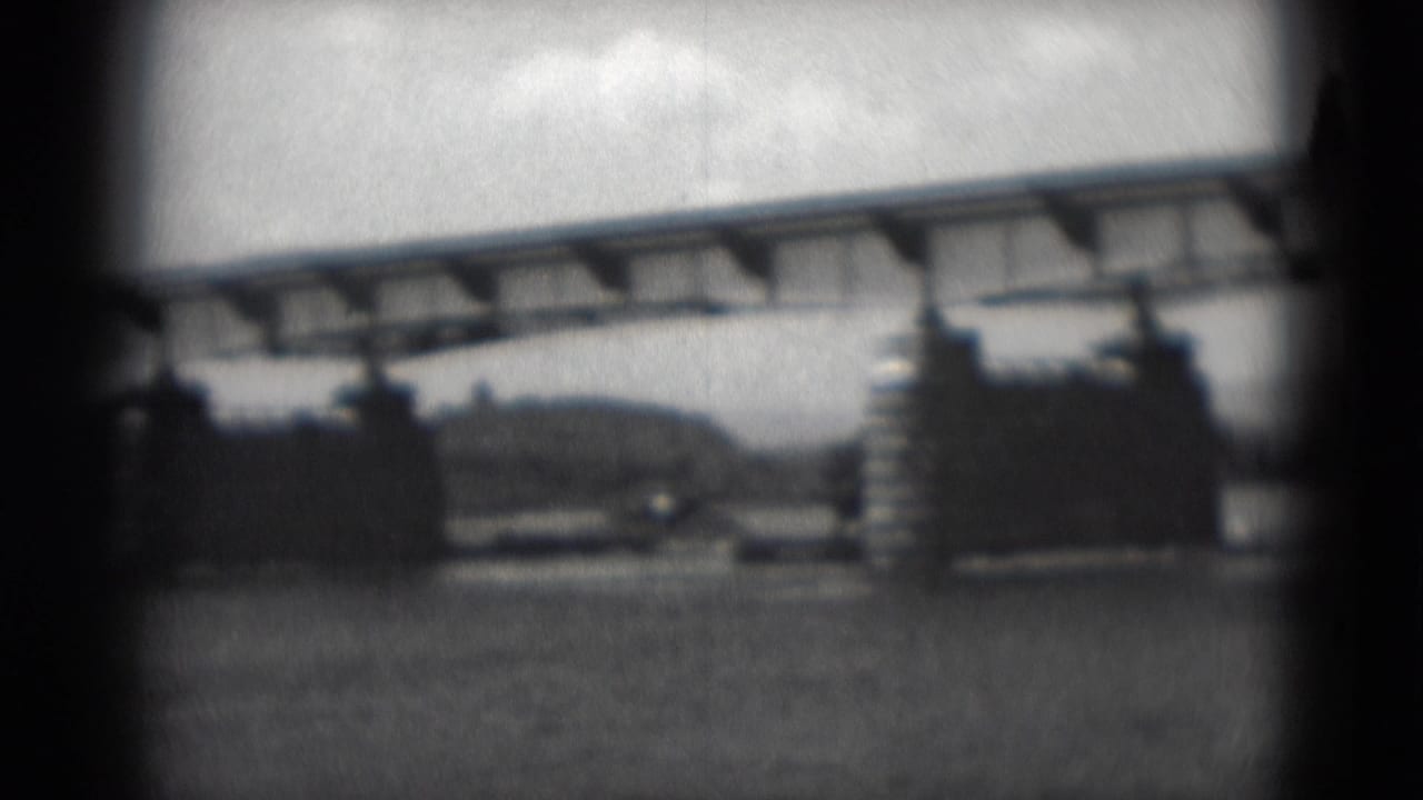 1975 8mm view in Middletown, Pennsylvania, showing a long bridge over water with stone-faced bridge structures and a distant shoreline.