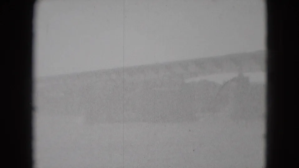 The final 8mm frame is overexposed and soft, with the river and bridge area barely visible through pale black-and-white film texture.