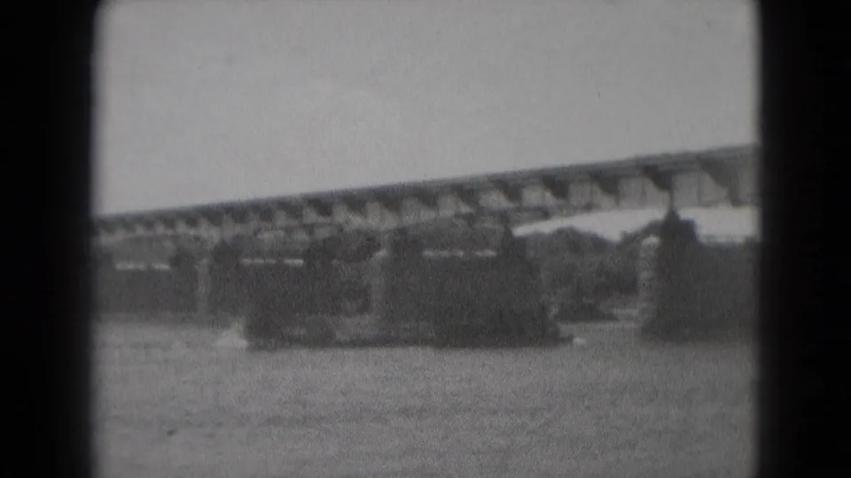 1975 Middletown, Pennsylvania home-movie frame showing a large vessel on the river with a bridge spanning the background.
