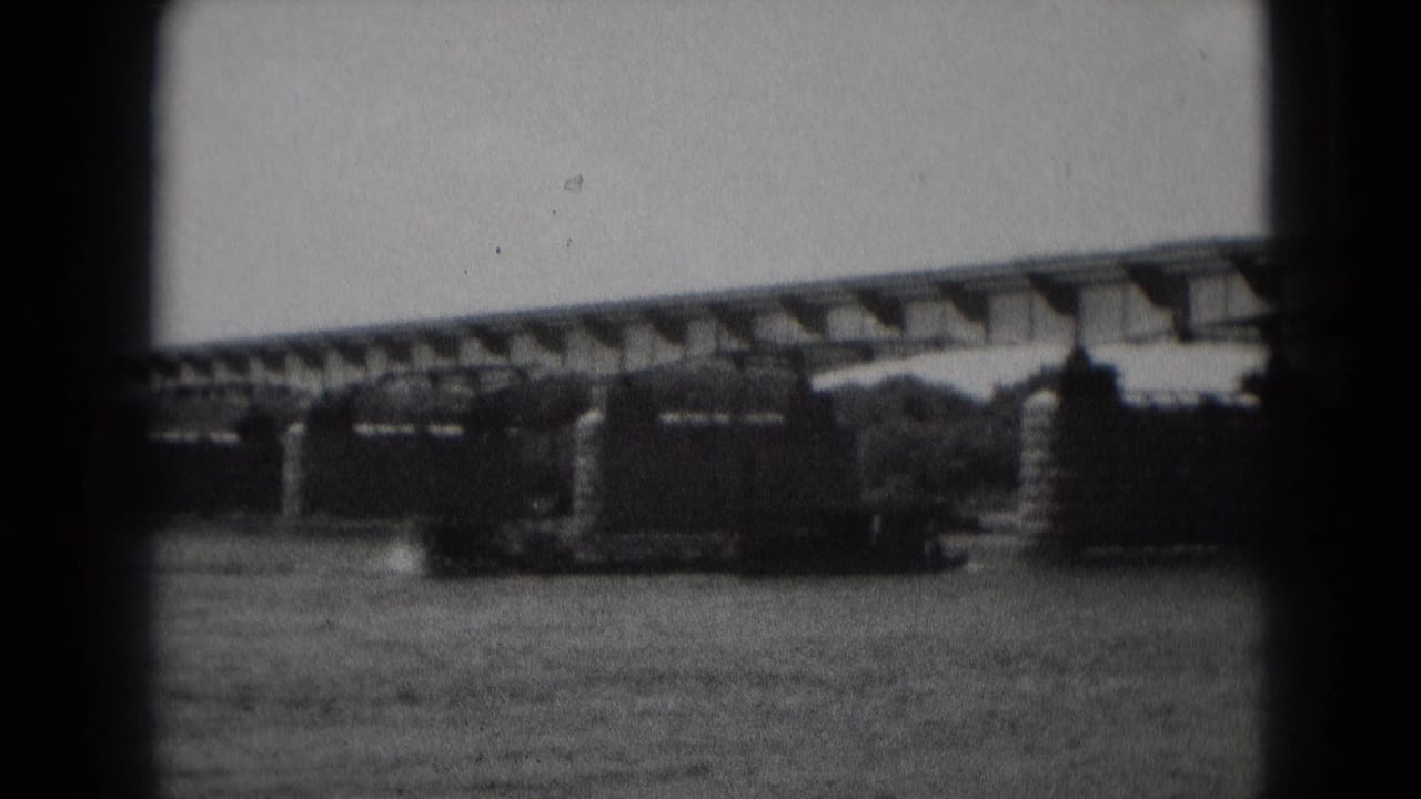 The vessel appears closer to the bridge supports as it moves across the river in the Middletown, Pennsylvania home-movie footage.