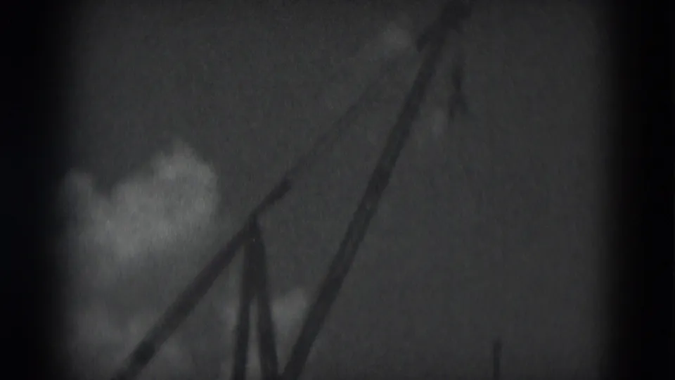 Final frame of the 1975 Middletown bridge construction clip, focusing on the crane boom and sky rather than the river span.