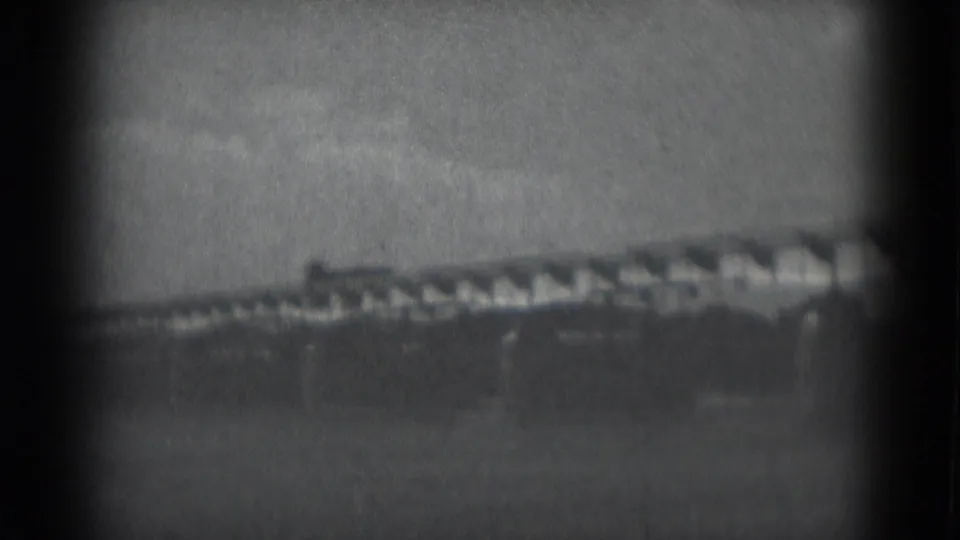 1975 8mm rural landscape near Middletown, Pennsylvania with a long low structure and tree line in the distance.
