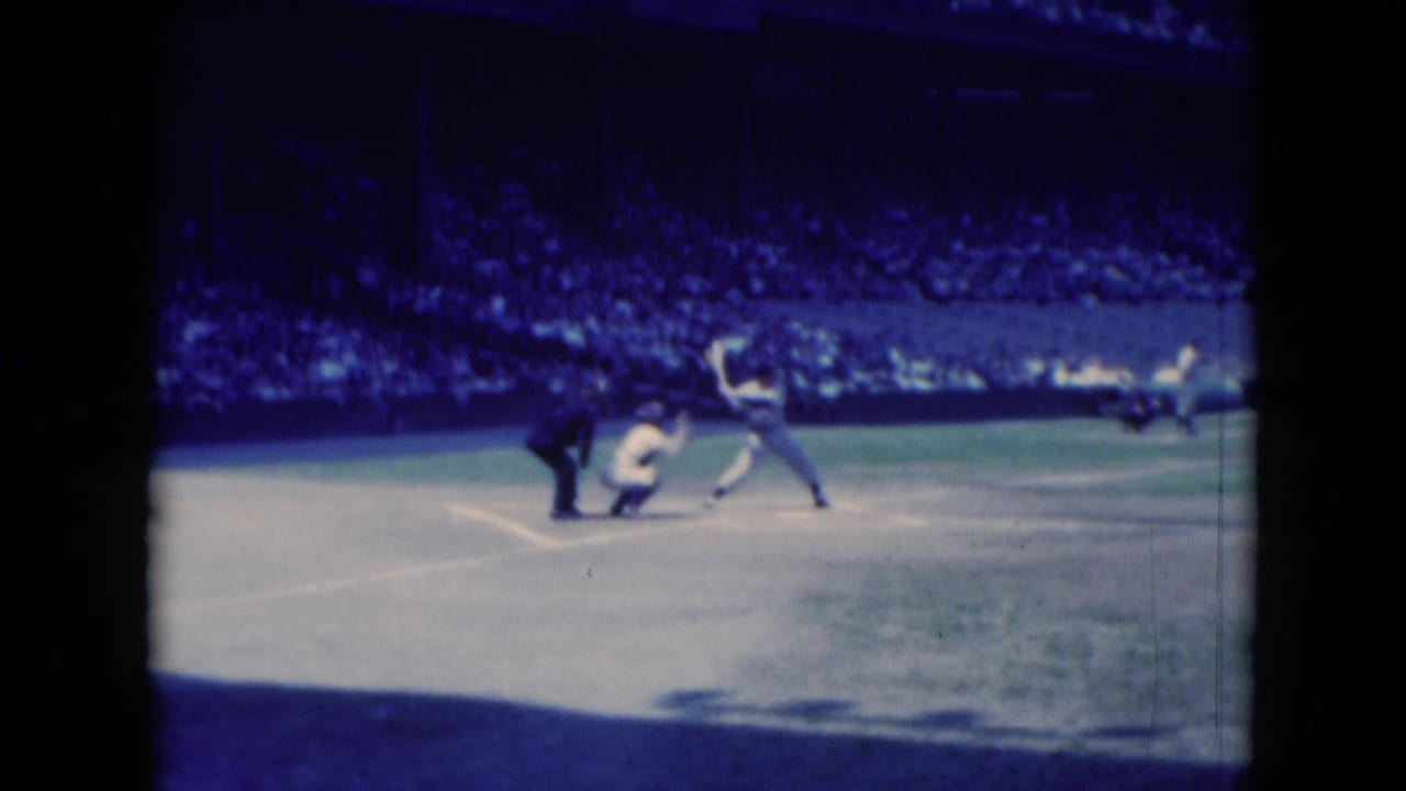 1975 Middletown, Pennsylvania 8mm frame showing a baseball batter swinging as the catcher and umpire watch near home plate.