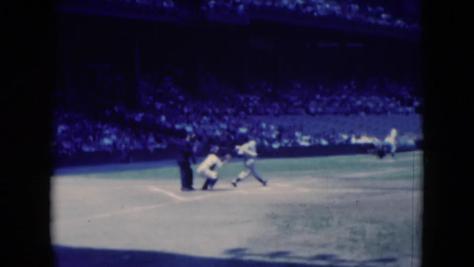 Middletown, Pennsylvania baseball scene from 1975 showing the batter following through while the catcher remains near home plate.
