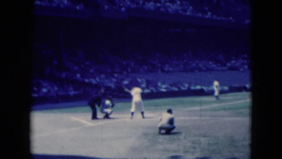 1975 Middletown, Pennsylvania baseball scene showing the batter area, catcher, umpire, and a crouched player in a soft 8mm frame.