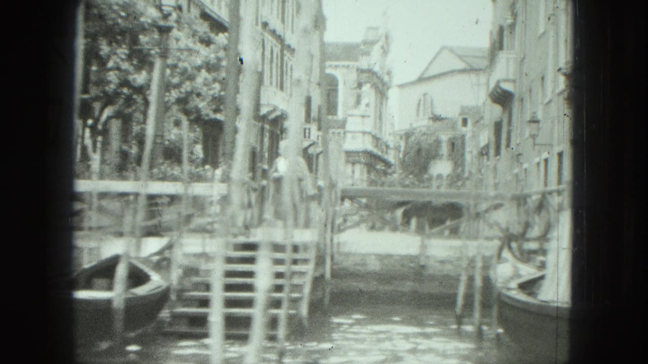 Woman standing by canal steps as a gondola passes near Venetian buildings.