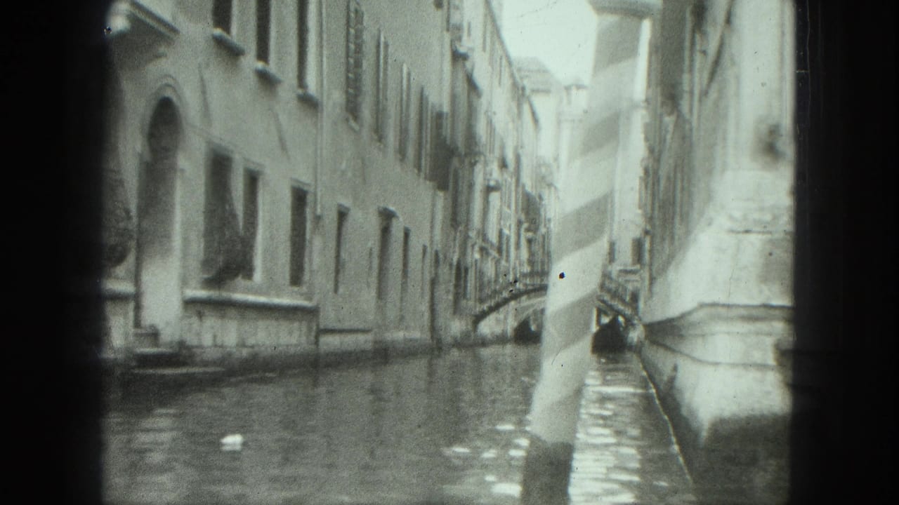 Canal view beside pale building walls with water reflections and distant bridge.