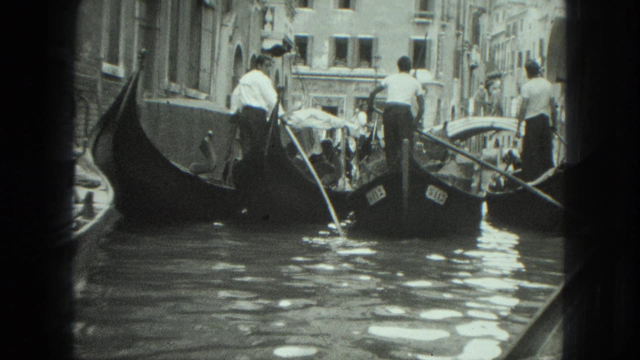 Gondolas and gondoliers moving through a narrow canal.