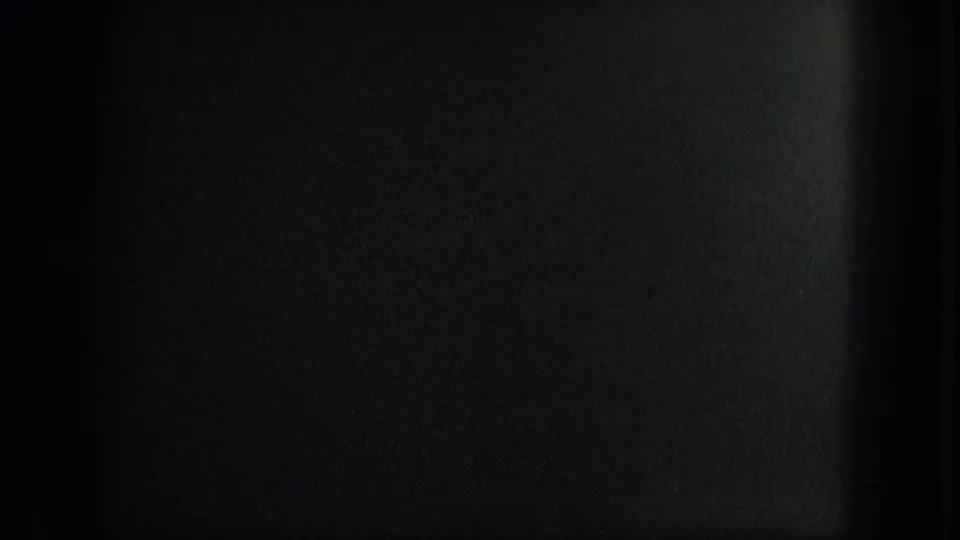 End frame from the 1975 Venice 8mm clip, largely obscured by dark exposure or film edge with minimal visible canal detail.