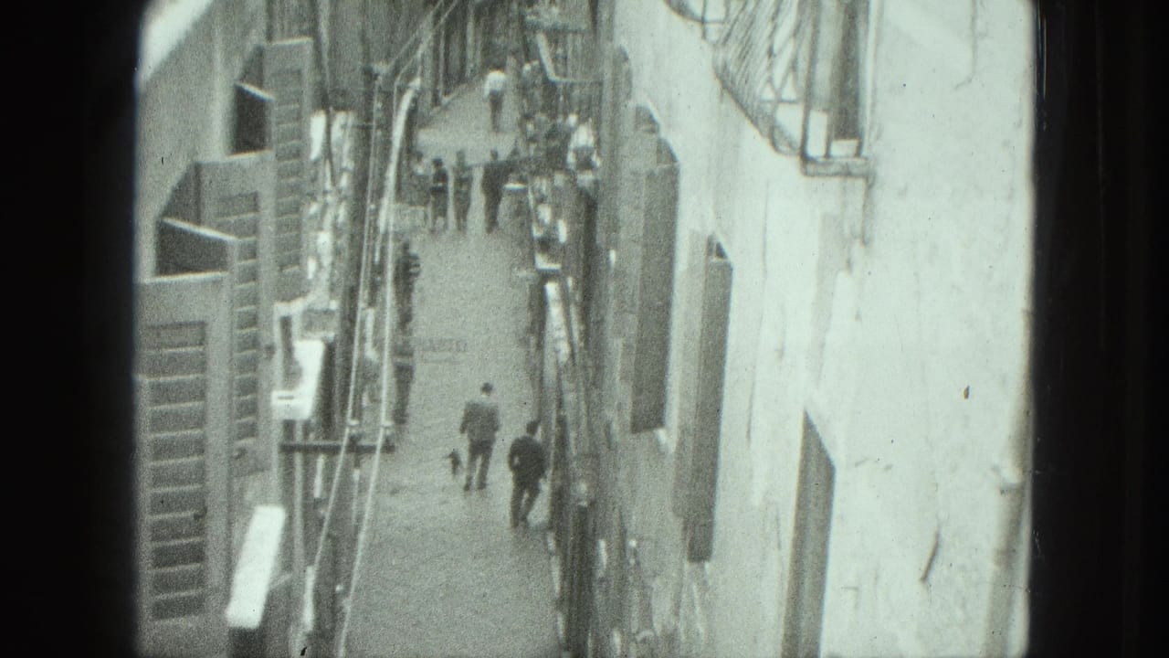 1975 Venice home-movie frame looking down on narrow pedestrian streets between close building walls.