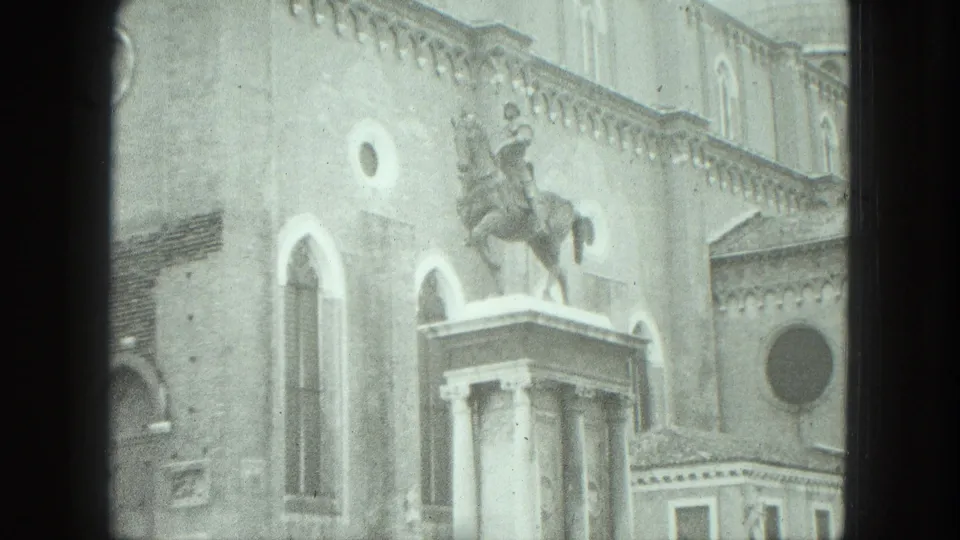 1975 Venice frame showing an equestrian statue raised above a classical pedestal against historic architecture.
