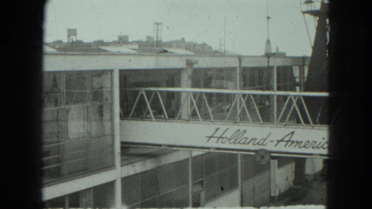 Mobile gangway with Holland-America Line lettering beside a glass-panel terminal building.
