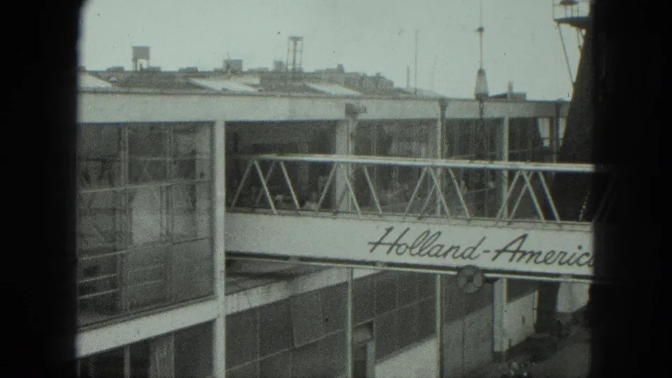 A 1975 Venice terminal view shows the Holland-America Line gangway partly blocked by dark vertical foreground bars.