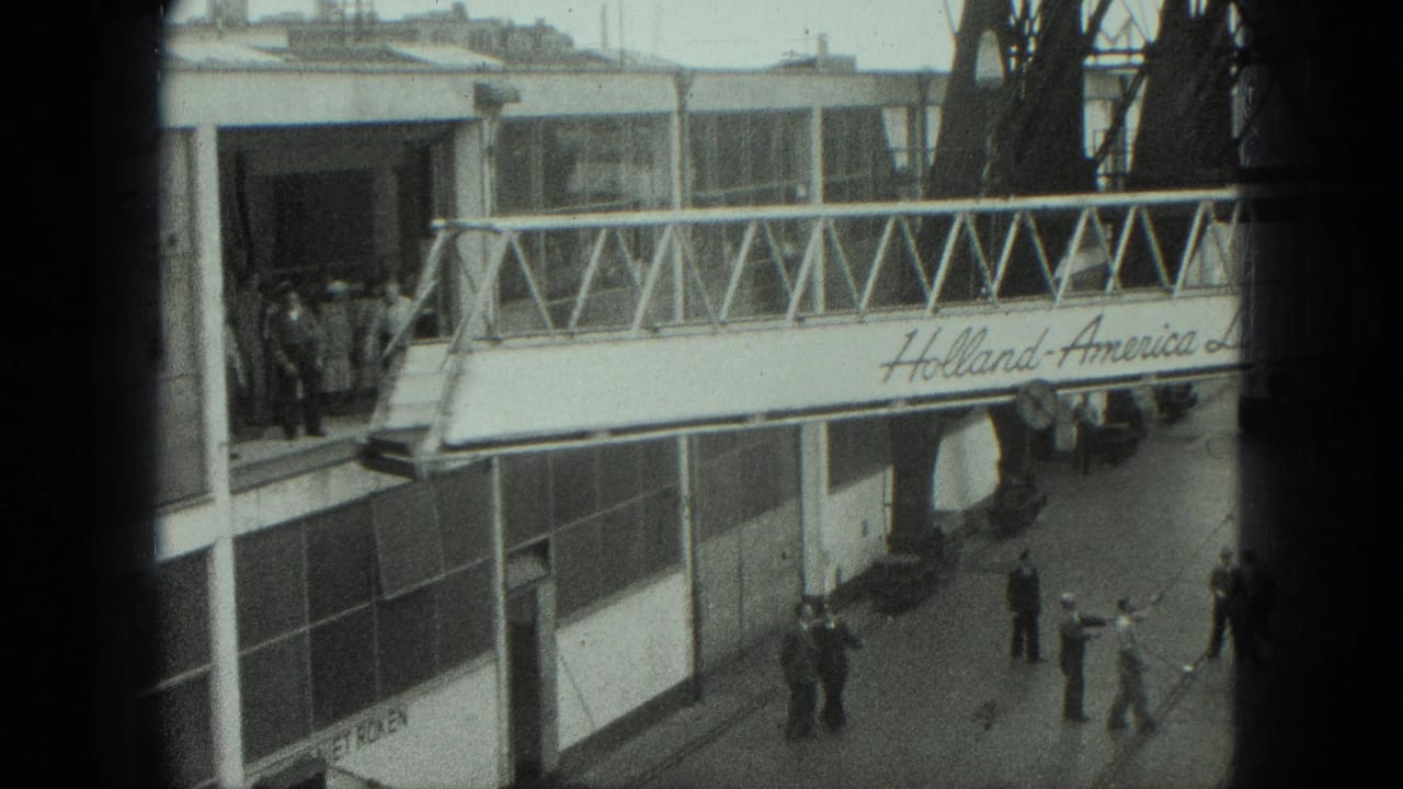 Gangway and terminal entrance with several people standing on the dock.