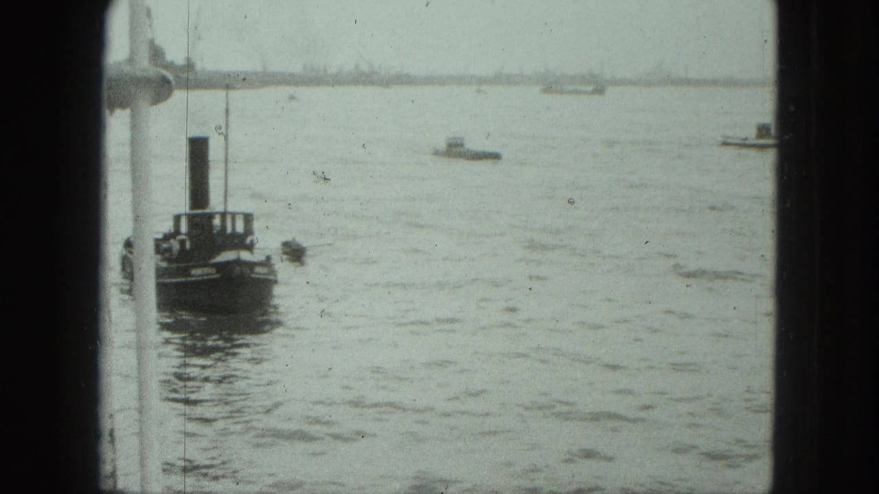 Small vessel with a tall funnel near a white window frame on open harbor water.