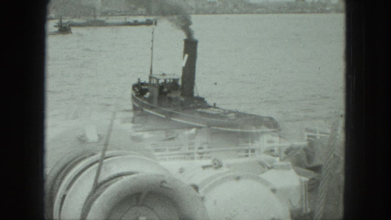 1975 Venice harbor footage showing a smoking tugboat on the water beyond rounded ship deck machinery and railings.