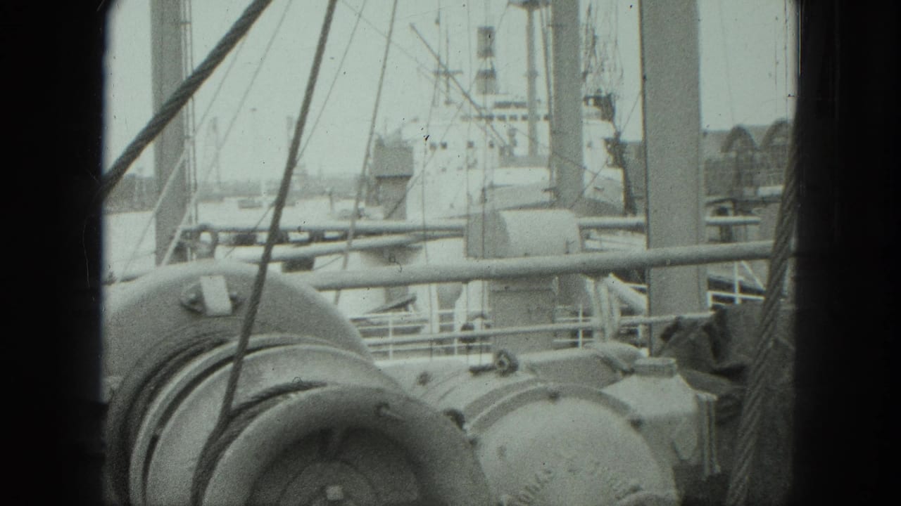 1975 Venice shipboard view of rounded deck machinery, rigging lines, railings, and a larger vessel structure beyond.