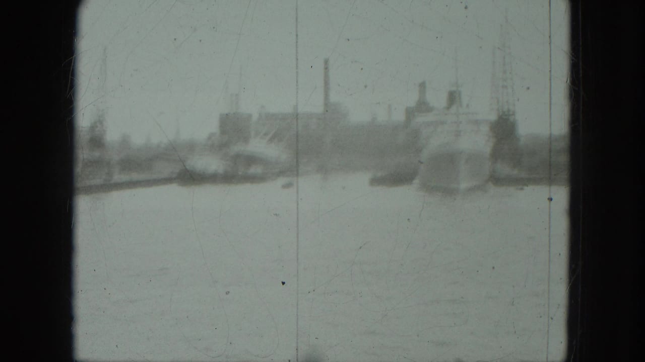1975 8mm Venice view across open water toward distant boats and an indistinct industrial shoreline.