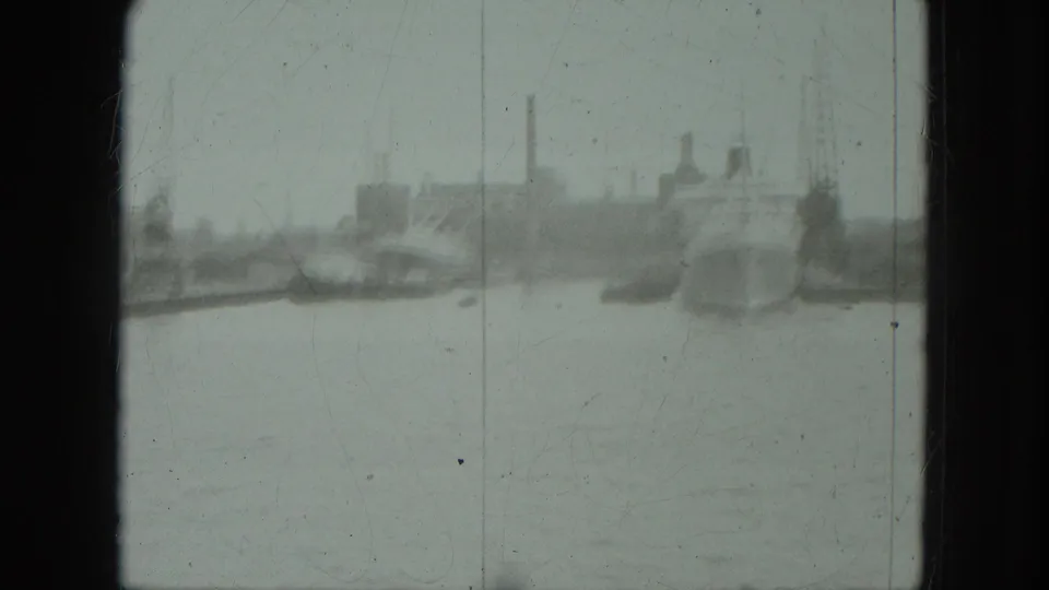 1975 8mm Venice view across open water toward distant boats and an indistinct industrial shoreline.