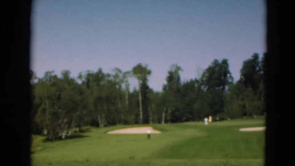 The final wide frame shows the golf course landscape, including sand traps, tree-lined fairway, blue sky, and distant people.