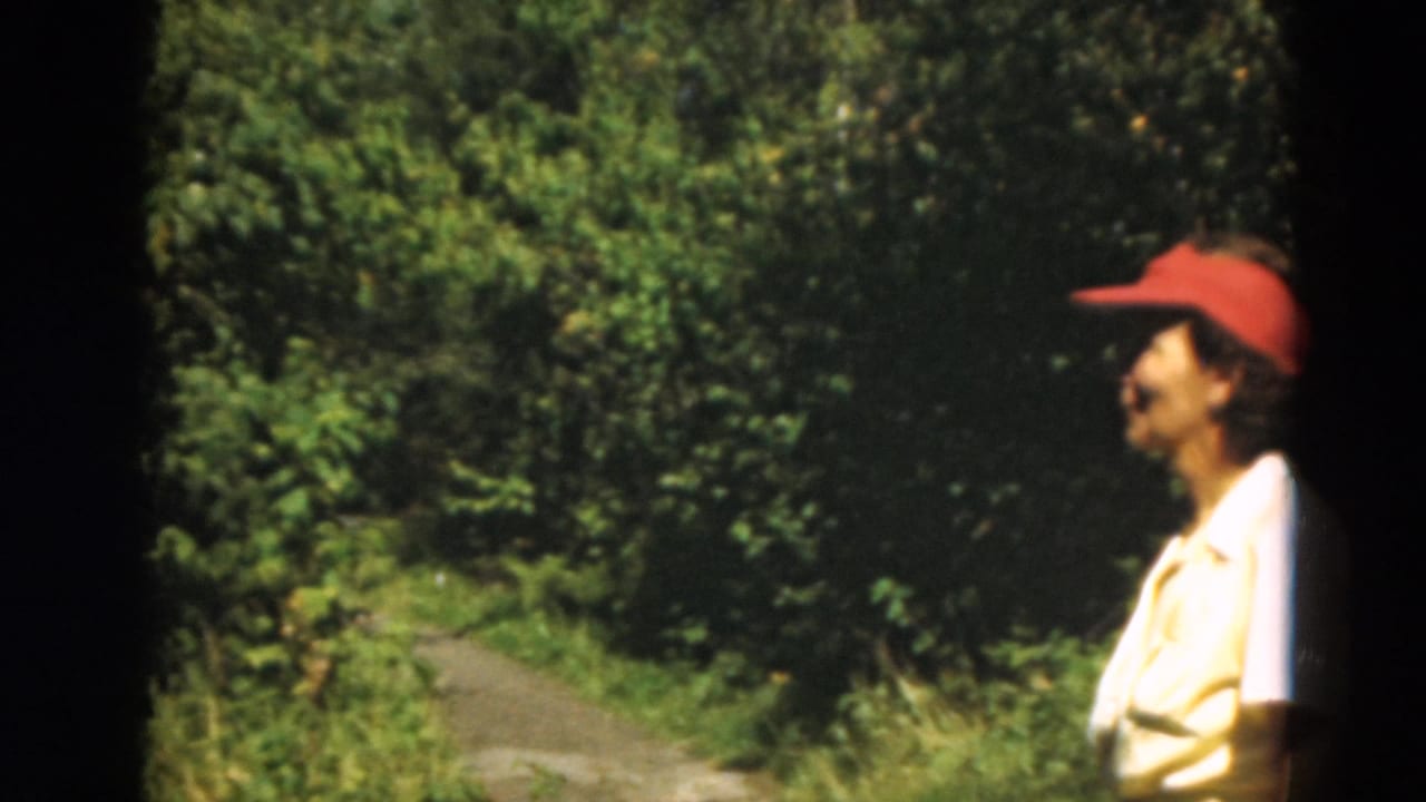Profile view of a woman in a red cap near a wooded golf-course path in Duluth, Minnesota, 1975.