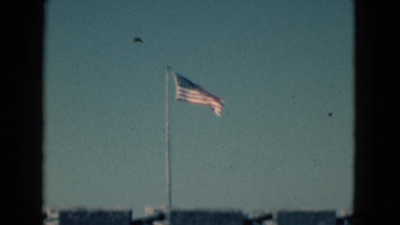 American flag flying against a blue sky above a historic stone fort in the 1975 Florida home-movie footage.