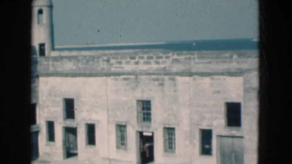 1975 Florida 8mm frame showing the stone fort wall from a slightly lower composition with windows and doorways.