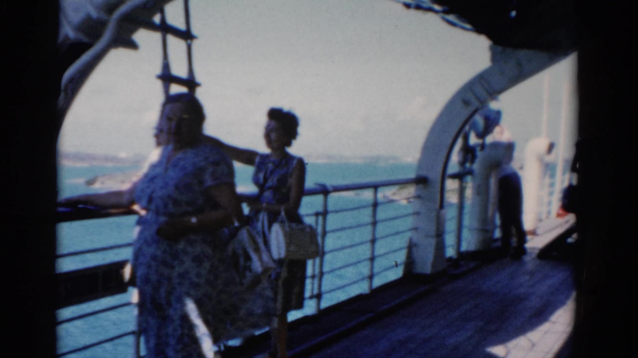 Three women passengers stand on a Florida cruise ship deck in 1975, looking over the railing toward the water.