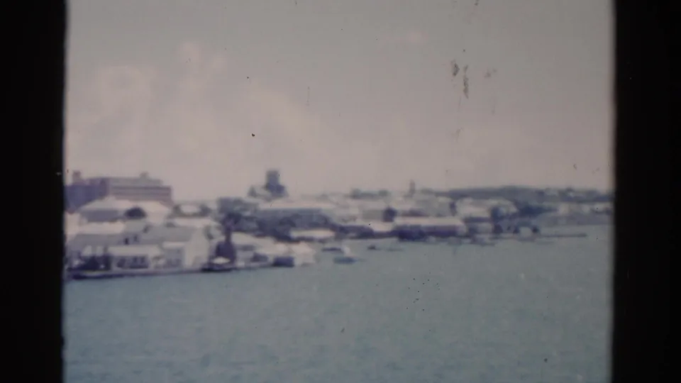 1975 Florida 8mm frame showing a soft waterfront panorama with white buildings and a tower-like form.
