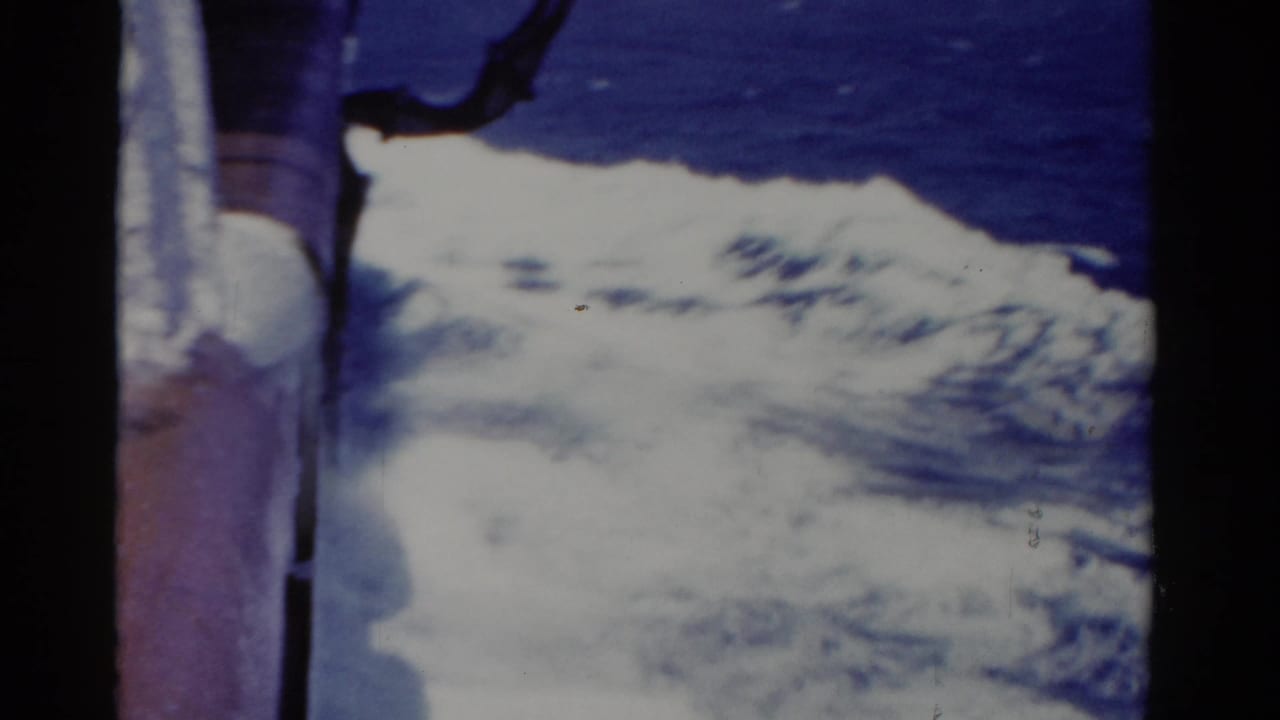 1975 Florida 8mm frame showing white boat wake and deep blue ocean seen from close to the vessel side.