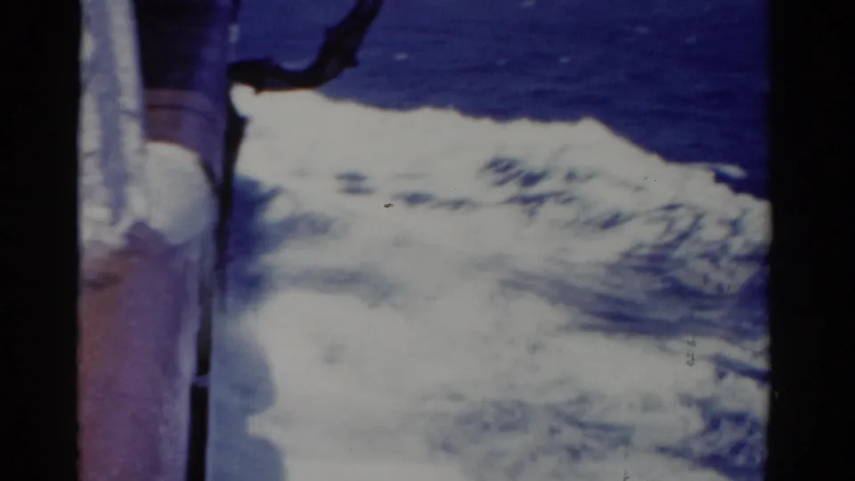 1975 Florida 8mm frame showing white boat wake and deep blue ocean seen from close to the vessel side.