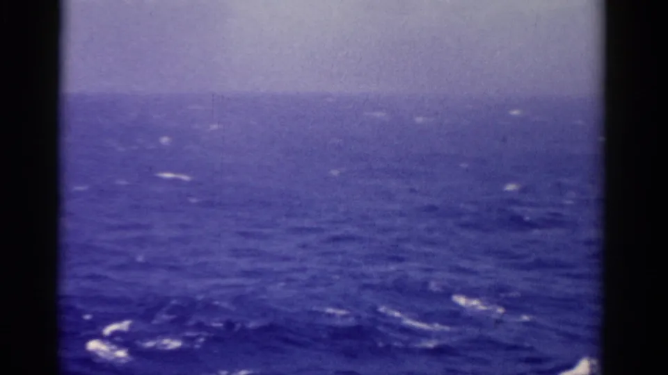 1975 Florida-linked 8mm view of choppy blue ocean and scattered whitecaps from a shipboard perspective.